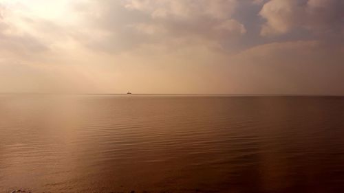 Scenic view of sea against sky at sunset