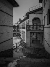 Empty alley amidst buildings in city