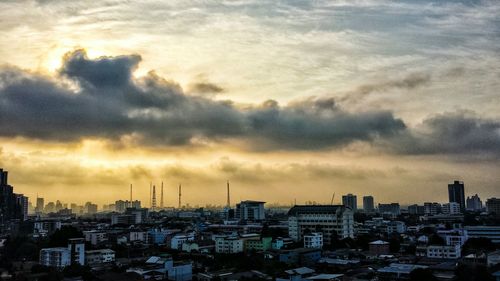 Cityscape against cloudy sky