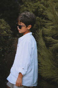 Side view of boy looking at camera