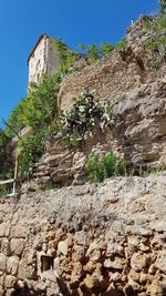 Low angle view of stone wall against sky