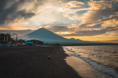 Scenic view of beach against sky during sunset