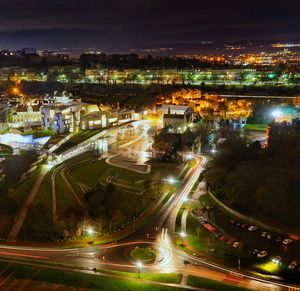 High angle view of illuminated city street and buildings at night