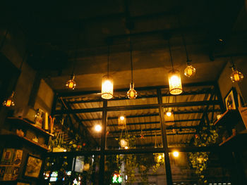 Low angle view of illuminated lanterns hanging at night