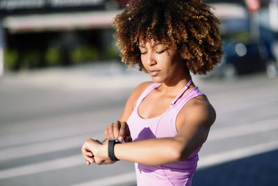 Young woman running on road