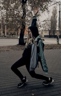 Woman on footpath in city