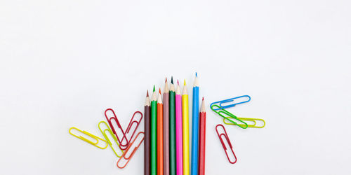 Close-up of colored pencils against white background