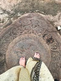 Low section of woman standing on ground