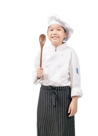 Portrait of smiling girl standing against white background