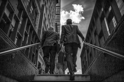 Low angle view of people walking on steps