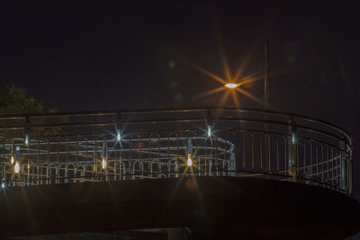 Low angle view of illuminated footbridge at night