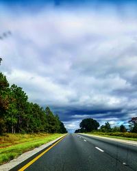 Empty road against cloudy sky