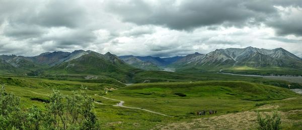 Scenic view of mountains against cloudy sky