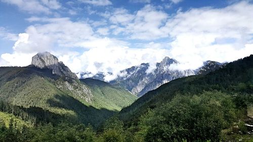 Scenic view of mountains against cloudy sky