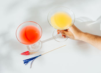 Alcoholic cocktails with marked shadows of the midday sun