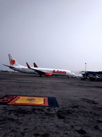 Airplane on airport runway against clear sky