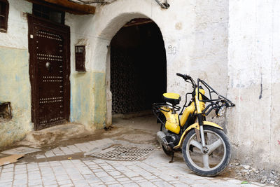 Motorcycle parked on street against building in city