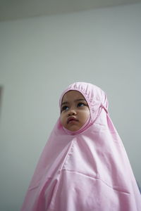 Portrait of a girl wearing hijab against white background