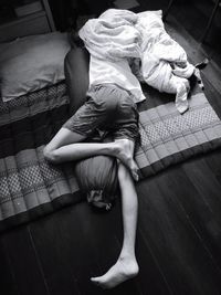 High angle view of man sleeping on mattress