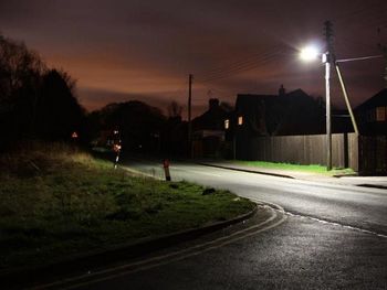 View of illuminated street lights at night