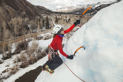 Woman climbs at ice park above lake city, colorado