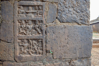 Close-up of stone sculpture against wall