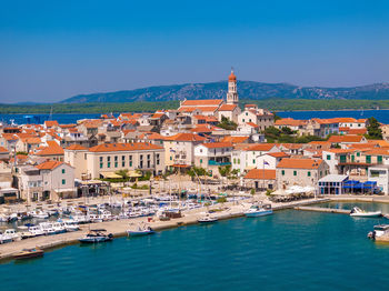 High angle view of townscape by sea against sky