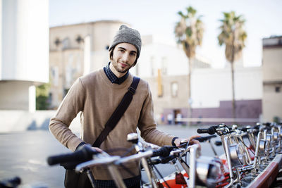 Portrait of smiling man at bicycle parking station