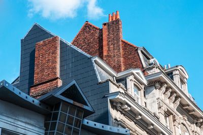 Low angle view of buildings against blue sky