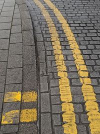 High angle view of yellow road marking on street