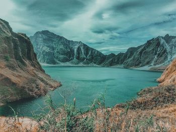 Scenic view of lake and mountains against sky