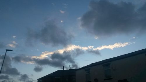 Low angle view of building against cloudy sky