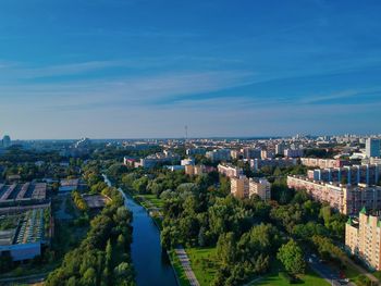 High angle view of buildings against blue sky