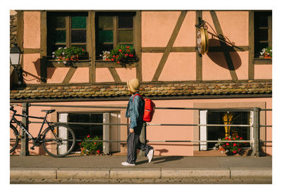 Rear view of man standing against wall