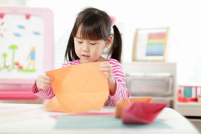 Young girl making craft for homeschooling