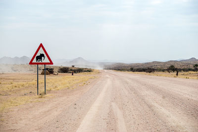 View of road sign against clear sky