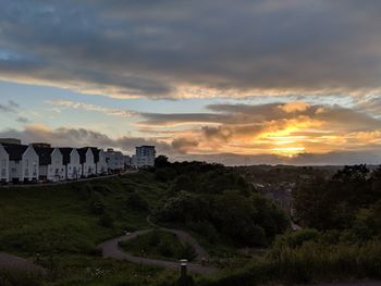 Scenic view of buildings against sky during sunset