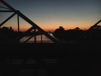 Silhouette bridge against sky during sunset