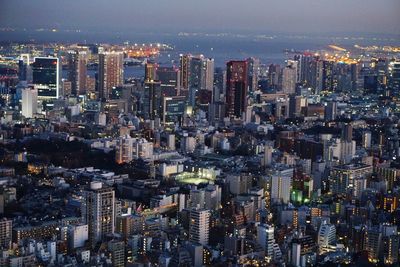 Aerial view of illuminated buildings in city at night