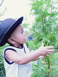 Midsection of cute boy against plants