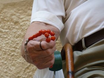 Close-up of hand holding chapelet