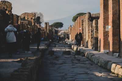 People walking on historical building in city