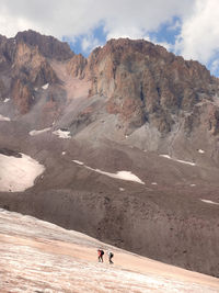 People on mountain road against sky