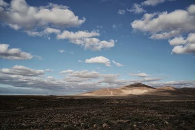 Scenic view of arid landscape against sky