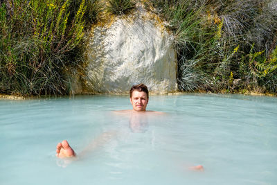 Portrait of young woman swimming in lake