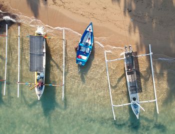 High angle view of boats moored on a sandy beach