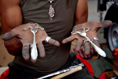 Midsection of man holding decoration at market for sale