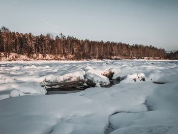 Snow covered landscape against sky