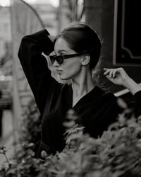 Portrait of young woman wearing sunglasses