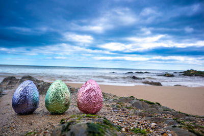 Surface level of pebbles on beach against sky